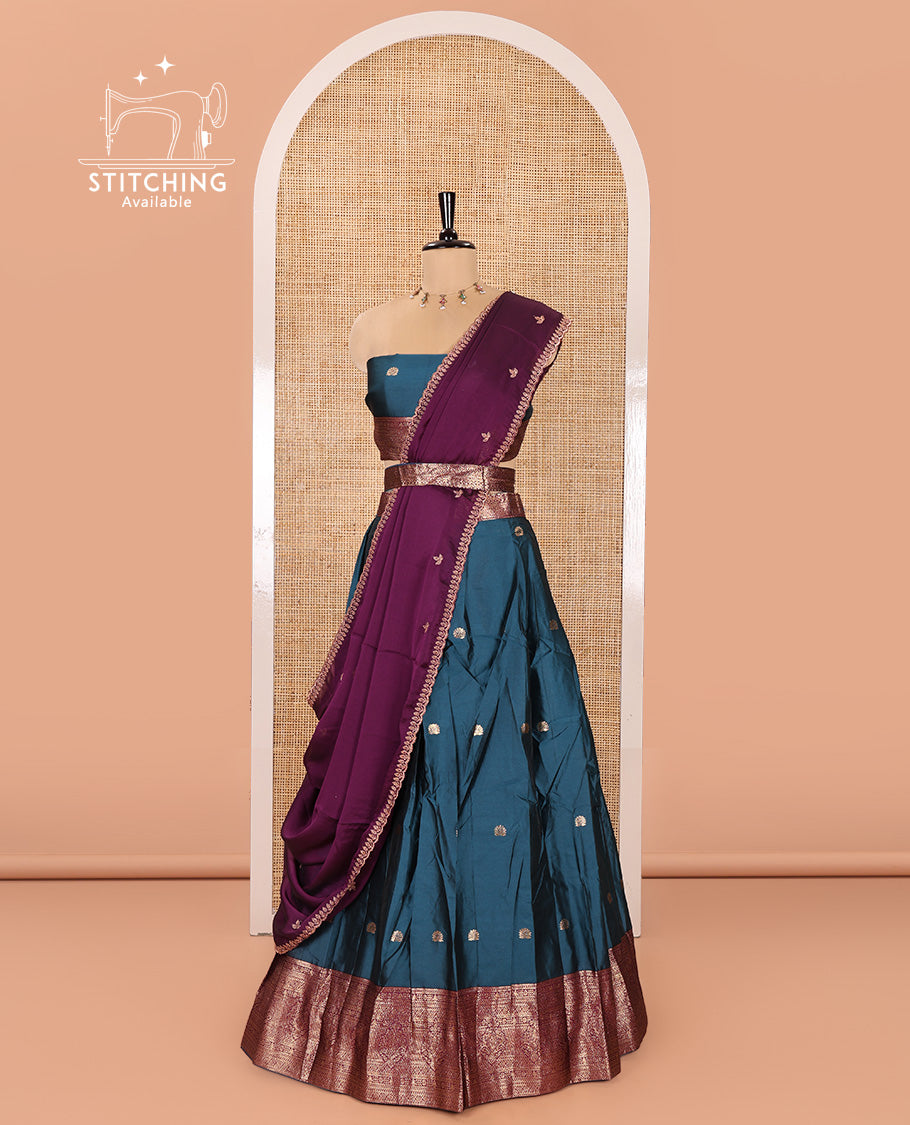 Blue and Purple Semi-Banarasi Half-Saree, Elevated with Zari Buttas on Its Skirt, Complemented by a Contrast Traditional Zari Designs Woven Border, Paired with a Matching Blouse, and a Satin Georgette Embroidered Scallop Dhavani