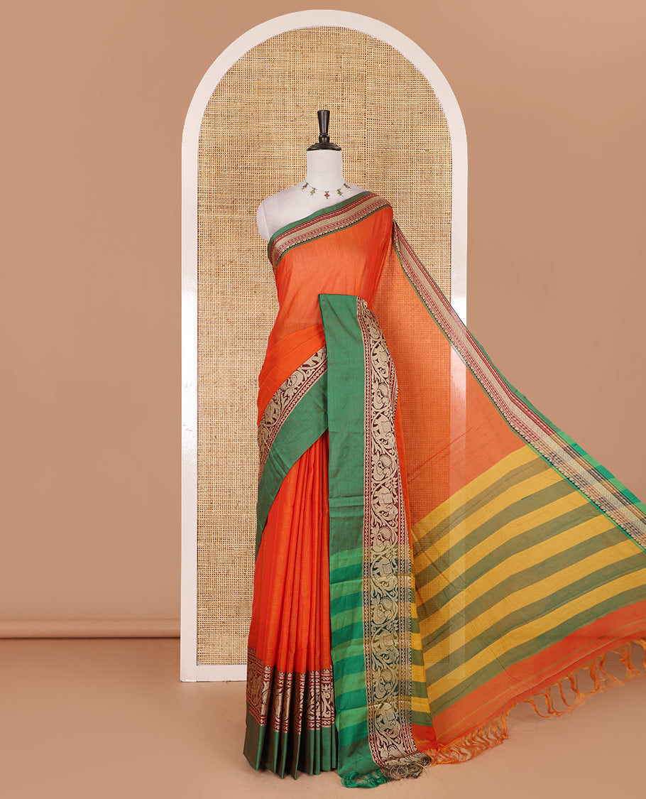 Orange plain mercerised cotton saree, contrast traditional border of peacock, and elephant motifs, striped pallu, and a matching blouse