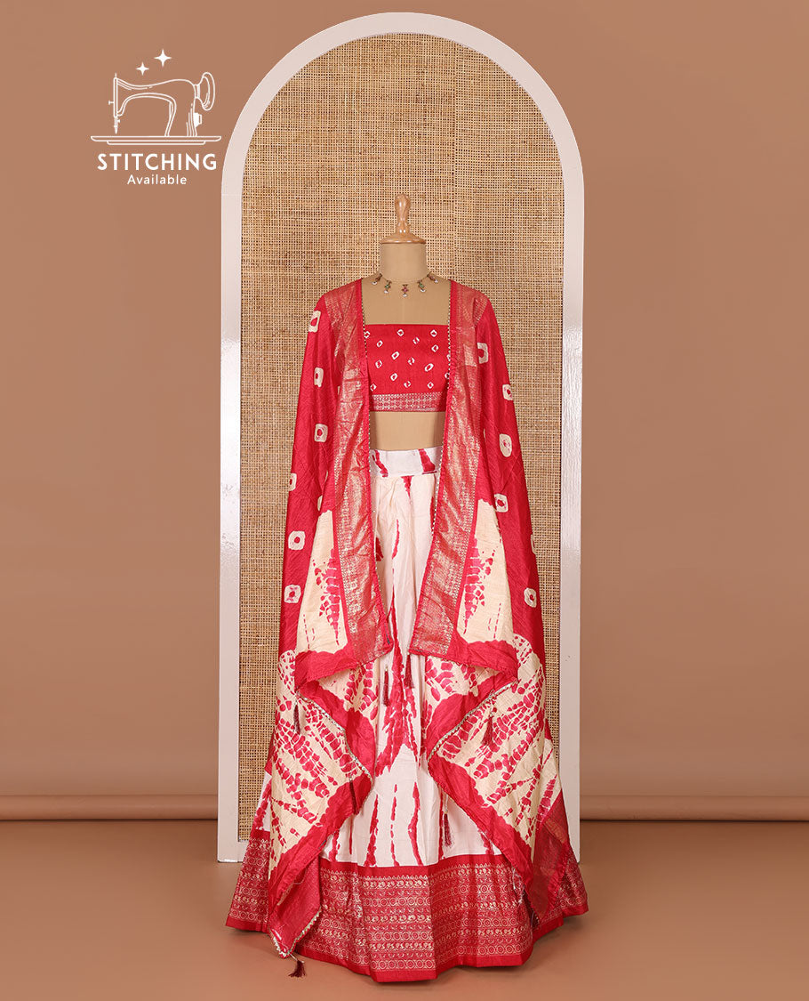 Cream and pink semi-tussar half-saree, shibori printed with contrast geometric patterned bordered skirt, bandhani printed blouse, and bandhani printed dhavani