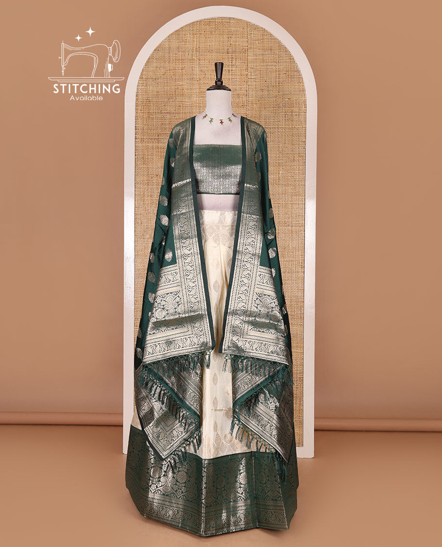 Cream with bottle green semi-banarasi half-saree, zari buttas with contrast traditional zari border skirt, zari jacquard blouse, and zari design dhavani