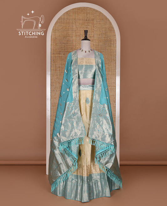 Cream taffeta silk half saree, meena buttas skirt, contrast blue traditional zari border, matching blouse, and zari woven dhavani