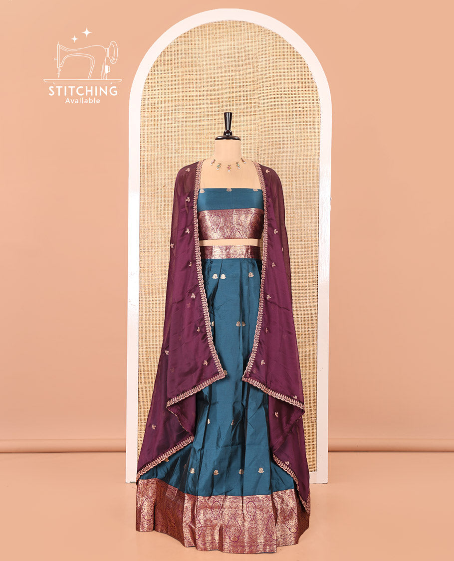 Peacock Blue and Magenta Semi-Banarasi Half-Saree, Accentulated with Zari Buttas on Its Skirt, Complemented by a Contrast Intricately Zari-Designed Border, Paired with a Matching Blouse, and a Contrast Satin Georgette Embroidered Scallop Dhavani