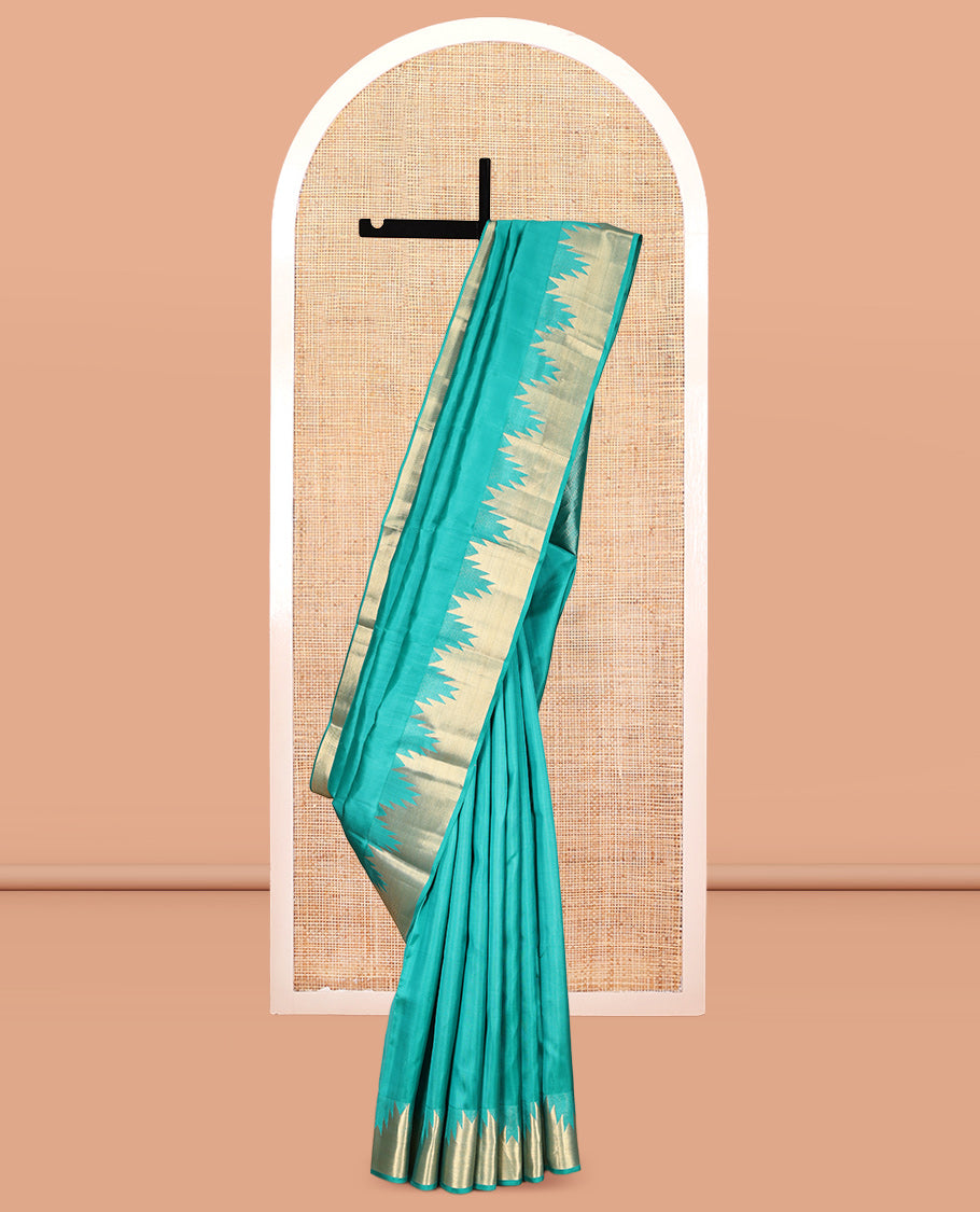 Green Plain Kanchipuram Silk Saree, Highlighted by a Zari Thazampoo Rekku Border, Geometric Patterned Pallu, and Matching Blouse
