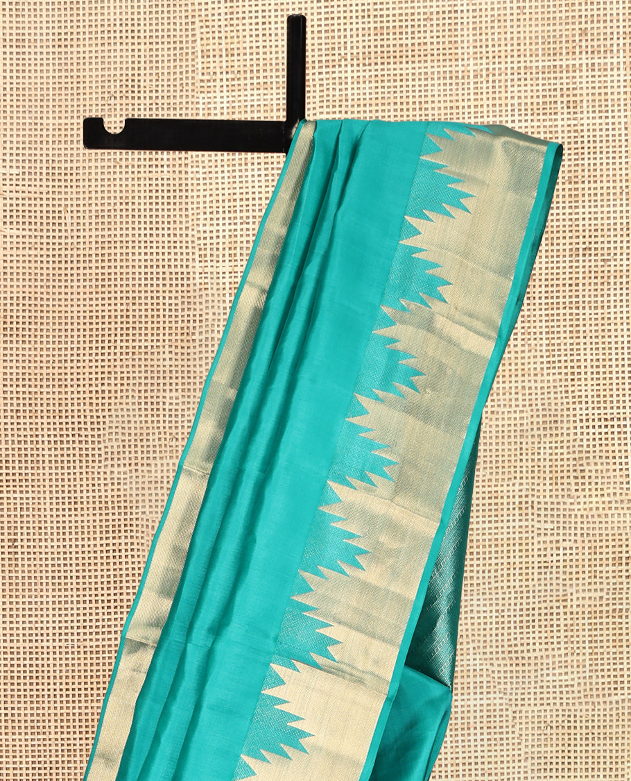 Green Plain Kanchipuram Silk Saree, Highlighted by a Zari Thazampoo Rekku Border, Geometric Patterned Pallu, and Matching Blouse