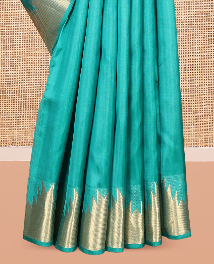 Green Plain Kanchipuram Silk Saree, Highlighted by a Zari Thazampoo Rekku Border, Geometric Patterned Pallu, and Matching Blouse