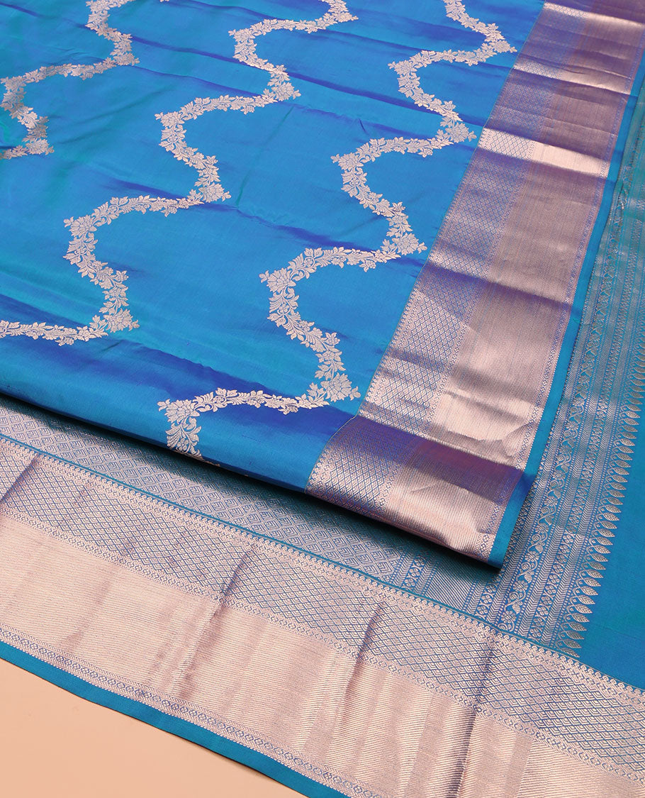 Blue Vasundhara Silk Saree, Delicately Woven with Jaal Jacquard Design All Over Its Body, Highlighted by a Zari Border of Thilakam Mokku, Jaal, and Lavangam Designs, Grand Jaal Pallu, and Paired with a Matching Blouse