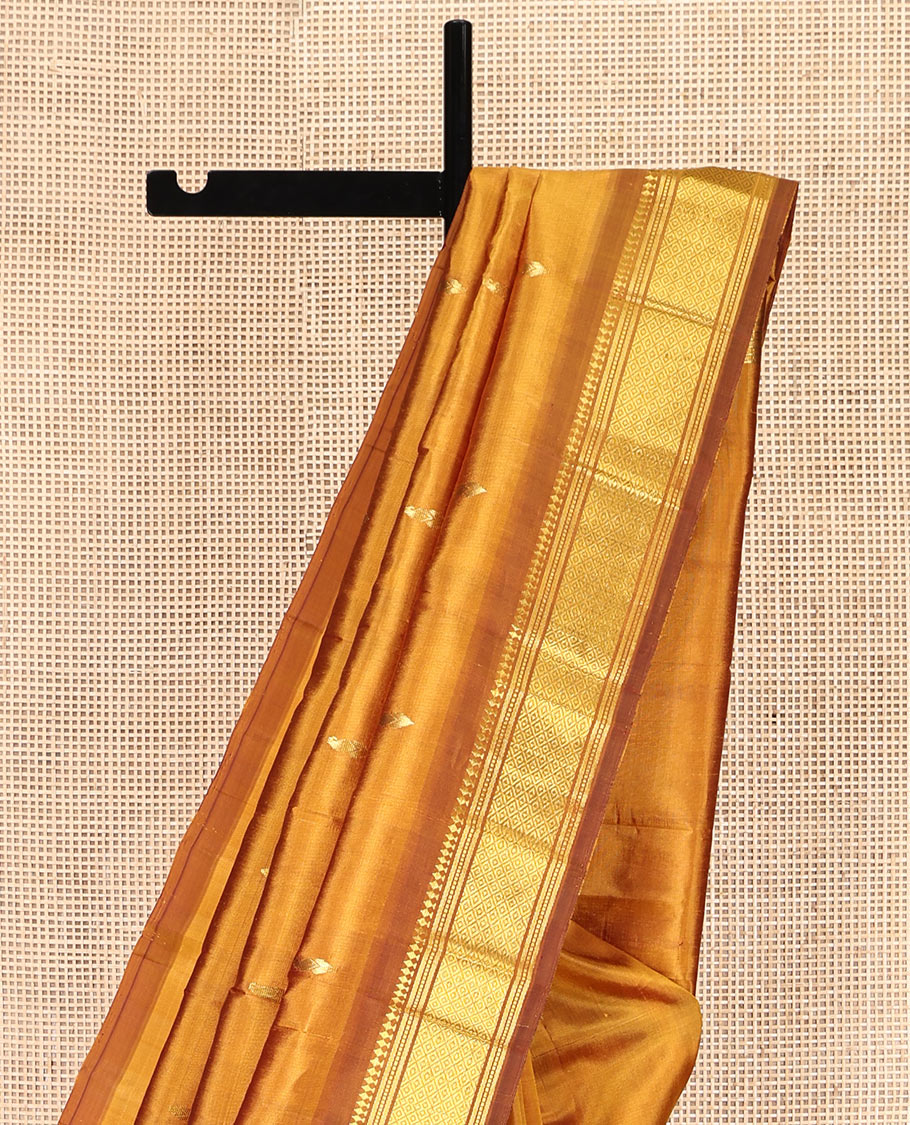 Mustard Kanchipuram Silk Saree, Adorned with Zari Buttas, a Contrast One-Sided Border of Panner Sombu, Banaras, Muthu, and Mayil Kann Designs, Zari Design Pallu, and No Blouse