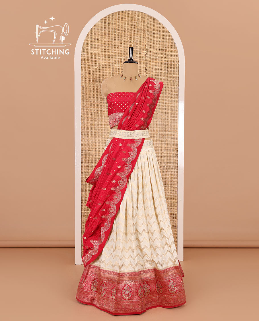 Cream-pink chiniya crepe half-saree, chevron zari jacquard with contrast intricate patterned stone work bordered skirt, contrast blouse, and a scallop bordered intricate dhavani
