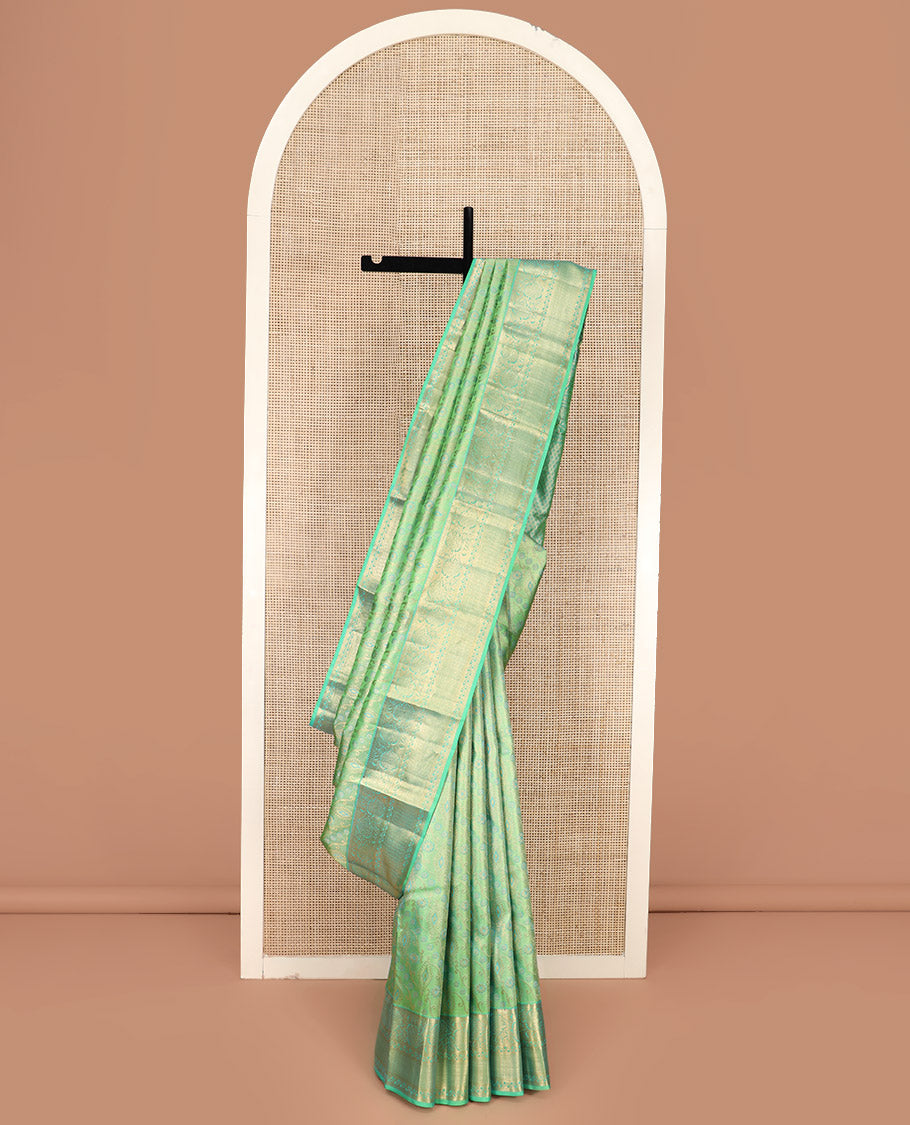 Green Kanchipuram Wedding Silk Saree Beautifully Bedecked with Meenakari Jacquard Designs, Highlighted with Contrast Border of Rekku, Kathir, and Kodi Visiry Designs, Grandly Decked Up Pallu of Jaal Designs, and Paired with a Contrast Blouse