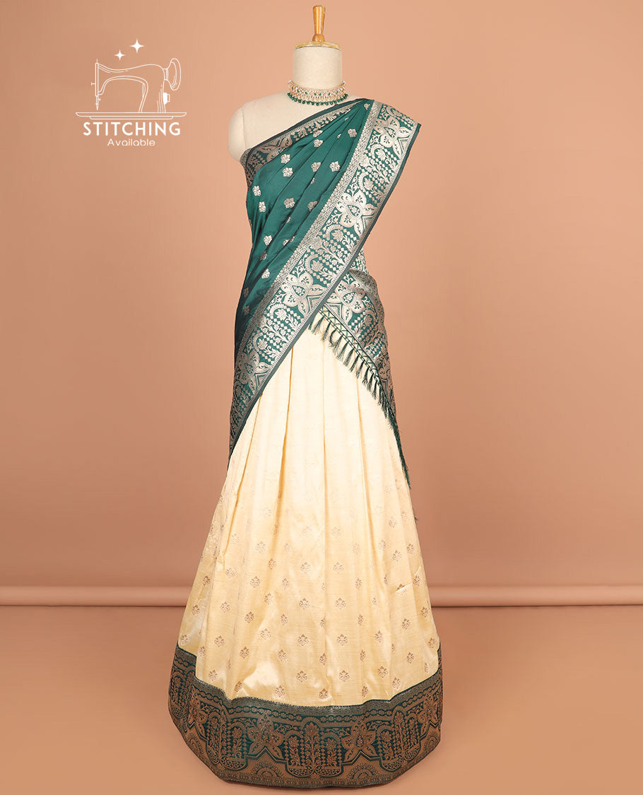 Cream buttas half saree with contrast zari design border, zari design blouse & green floral vine zari design dhavani