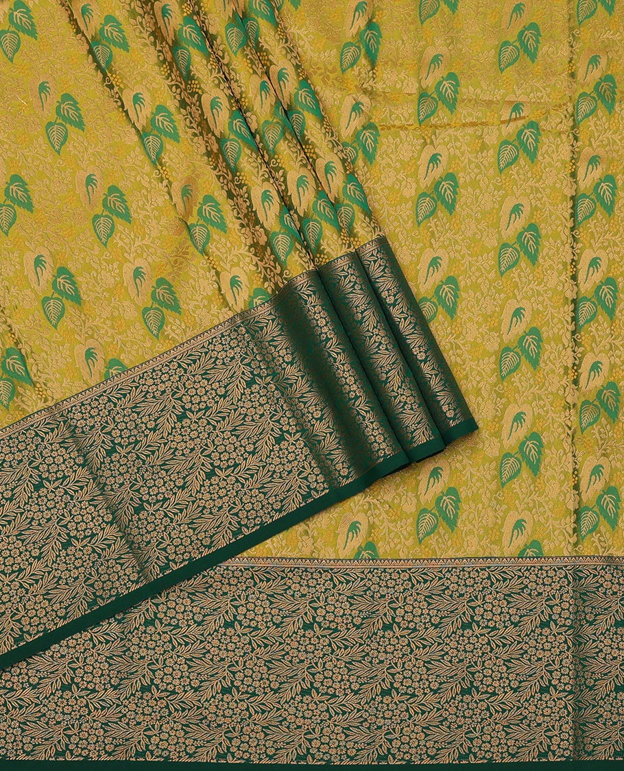 Green Art Silk Pavadai Material Set Mesmerized with Leaf Jacquard Design on Its Skirt, Complemented by a Contrast Floral Zari Design Border, and Paired with a Contrast Blouse