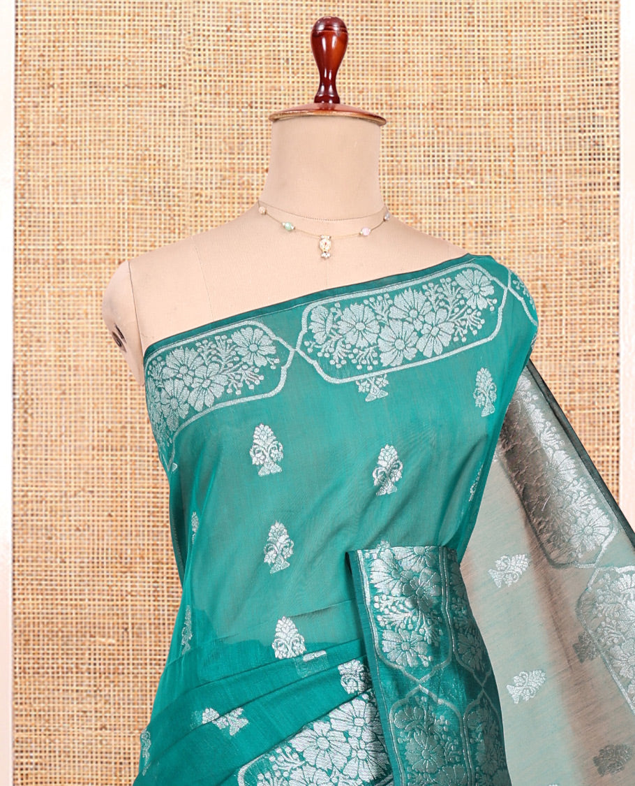 Green Semi-Silk Cotton Saree, Elevated with Zari Buttas All Over Its Body, a Subtle Border of Floral Designs, Grand Jaal Pallu, and Paired with a Matching Blouse