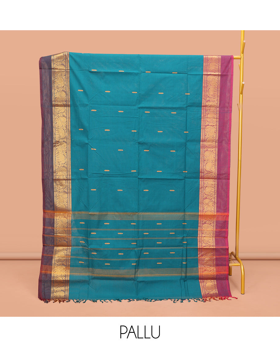 Blue Chettinad Cotton Saree, Adorned with Buttas All Over Its Body, Complemented by a Contrast Ganga-Jamuna Kal Eragina Border of Kodi Peacock and Elephant Designs, Pallu of Buttas and Stripes, and Paired with a Matching Blouse