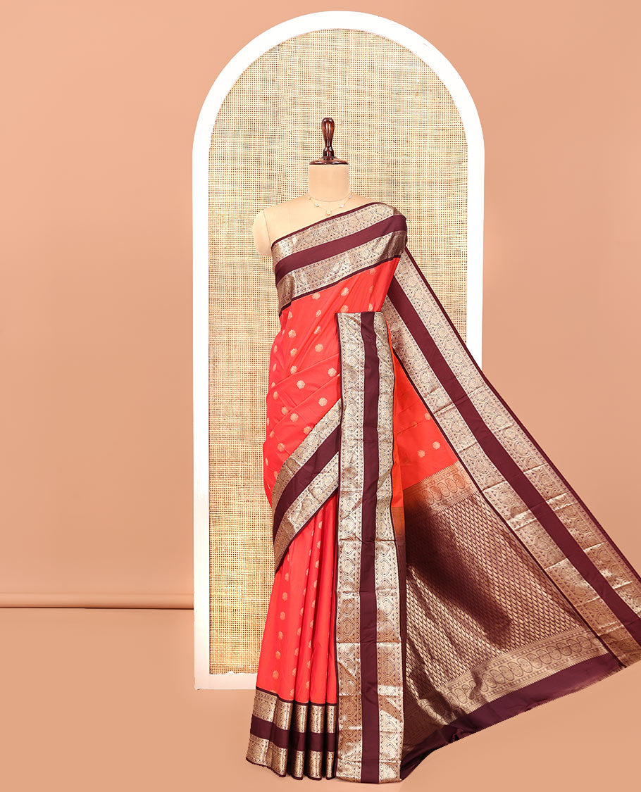 Orange and Brown Budget Silk Saree, Adorned with Zari Buttas All Over Its Body, Complemented by Contrast Rettai Pettu Traditional Zari Border of Jada Nagam, Pallu Steeped with Paisleys, and Paired with a Contrast Blouse
