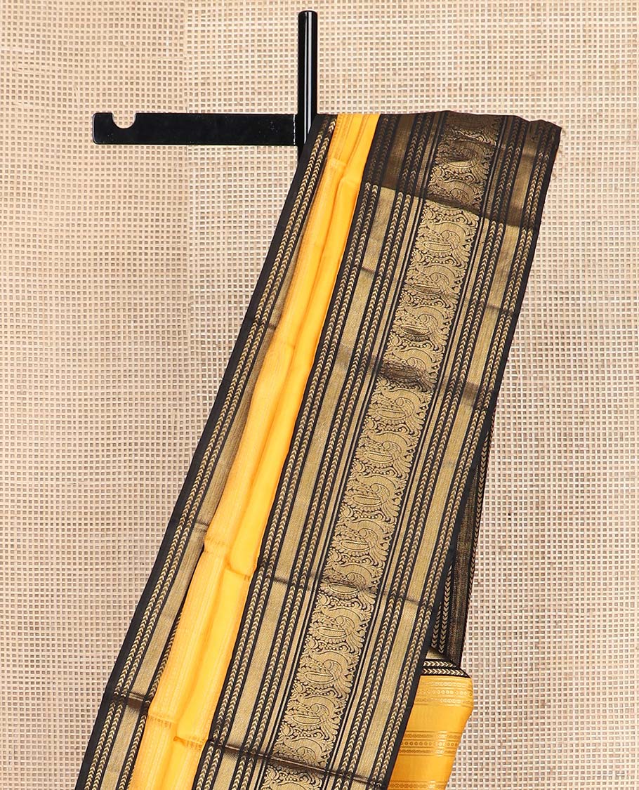 Yellow zari striped Kanchipuram silksaree, contrast border of kathir, and mayil designs, and pallu of mayil kann designs