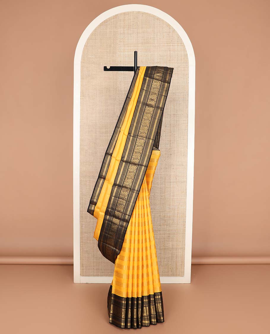 Yellow zari striped Kanchipuram silksaree, contrast border of kathir, and mayil designs, and pallu of mayil kann designs