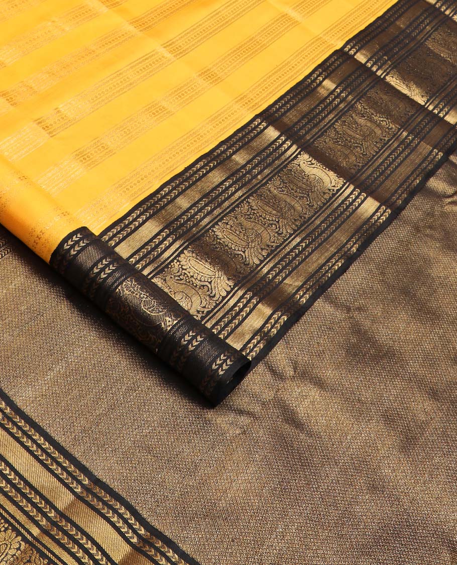 Yellow zari striped Kanchipuram silksaree, contrast border of kathir, and mayil designs, and pallu of mayil kann designs
