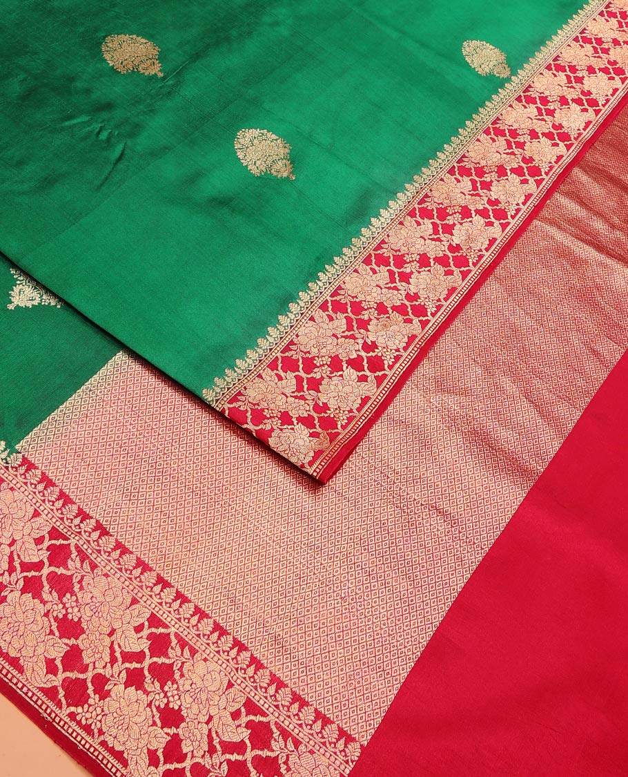 Green Raw Mango Silk Saree Ornamented with Buttas, Complemented by a Contrast Traditional Zari-Design Border, Pallu Depicts Peacock Eye Design, and Paired with a Contrast Blouse