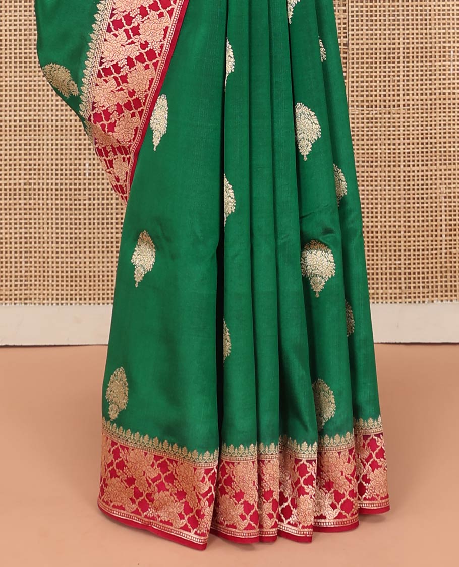 Green Raw Mango Silk Saree Ornamented with Buttas, Complemented by a Contrast Traditional Zari-Design Border, Pallu Depicts Peacock Eye Design, and Paired with a Contrast Blouse