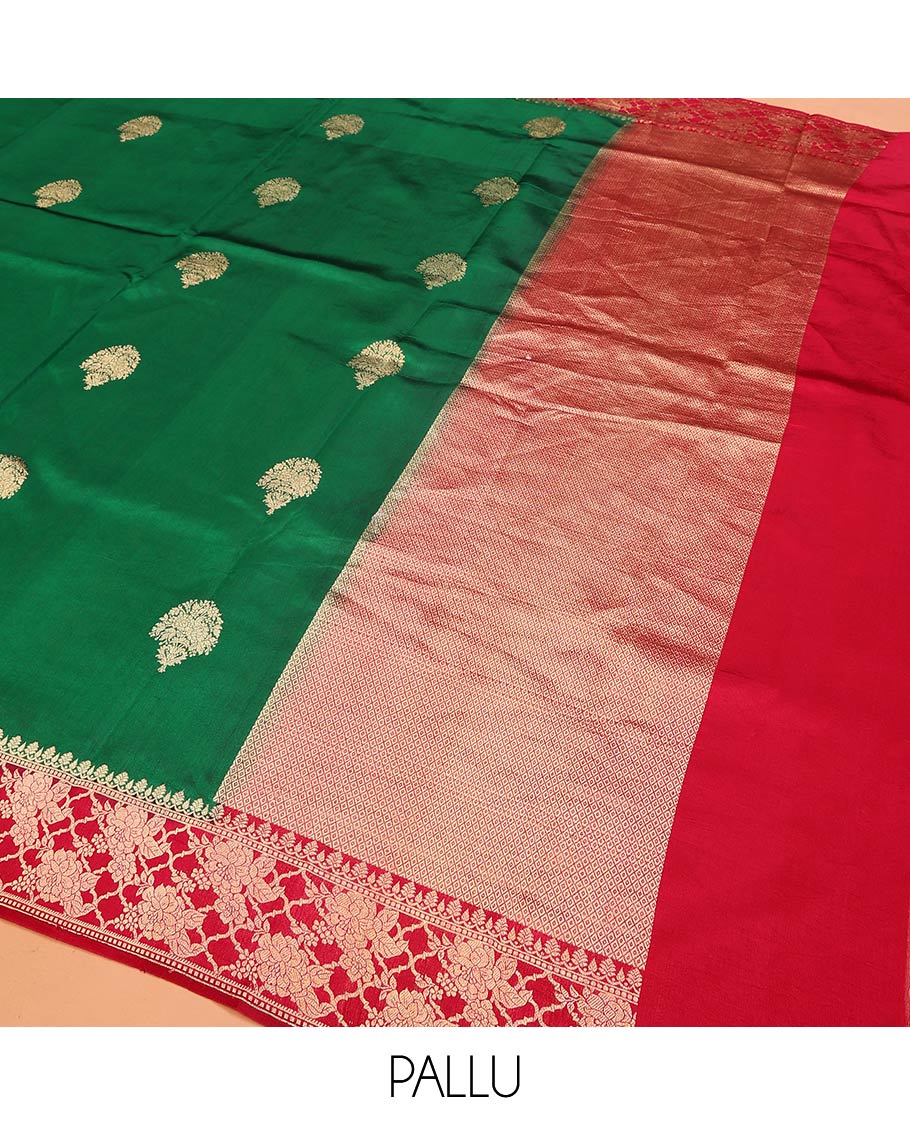 Green Raw Mango Silk Saree Ornamented with Buttas, Complemented by a Contrast Traditional Zari-Design Border, Pallu Depicts Peacock Eye Design, and Paired with a Contrast Blouse