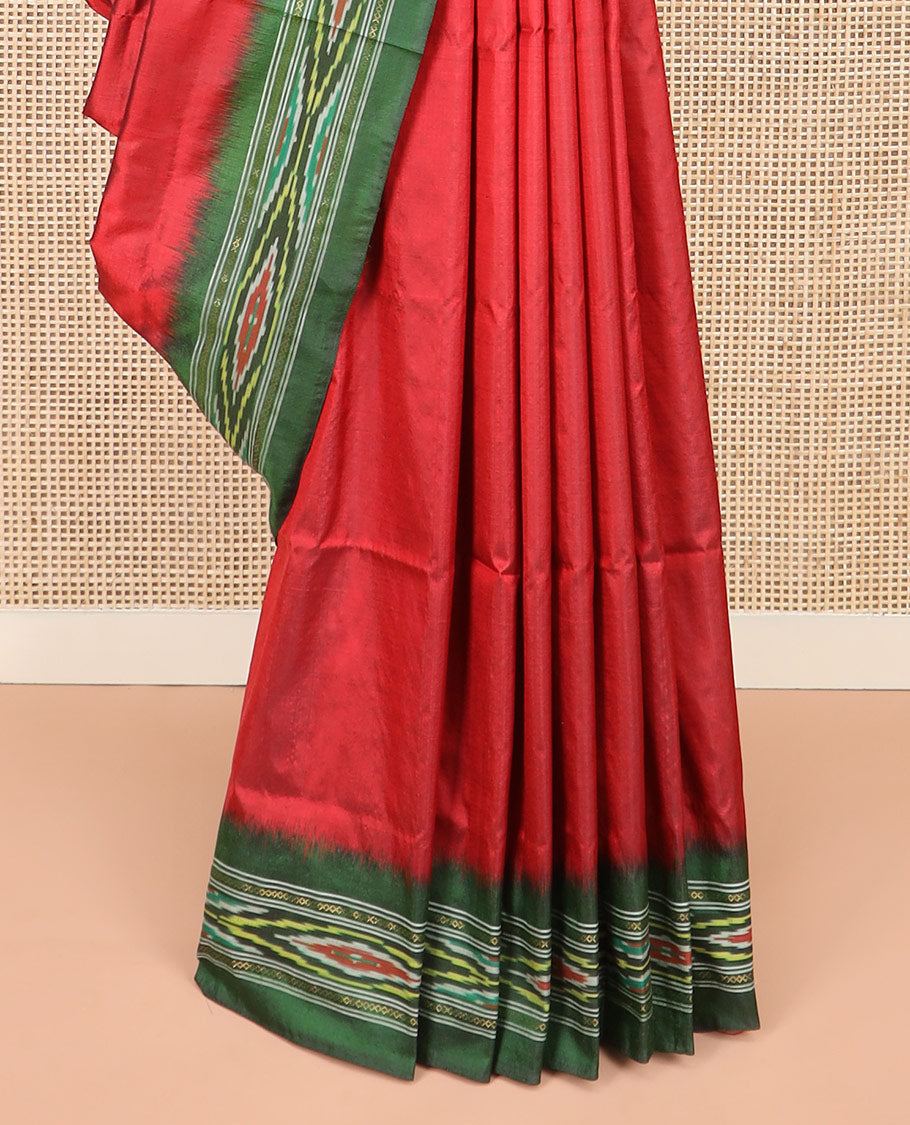 Persian Red Plain Ikkat Silk Saree with a Contrast Green Border Beautified by a Hazy Ikkat Weave, and a Pallu Depicting Stripes and Ikkat Texture