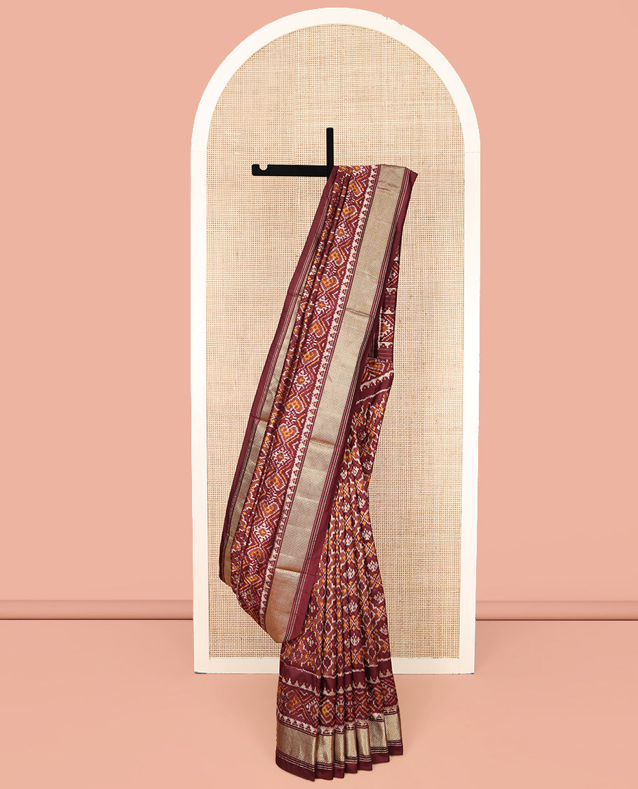 Brown Ikkat Silk Saree, Elevated with Ikkat Checks All Over Its Body, Subtle Border of Jaal Designs, Pallu of Geometric Designs, and Paired with a Matching Blouse