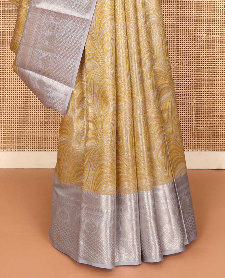 Yellow jacquard Kanchipuram tissue silk saree, contrast border of thilakam mokku, muthu, kathir, puli nagam, and jaal designs, and butta enclosed checks