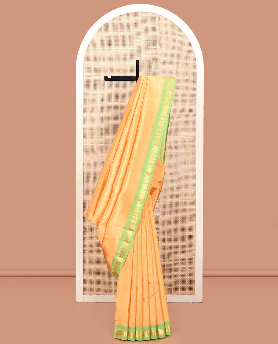 Orange Kanchipuram Silk Saree, Sparsely Woven with Zari Buttas, a Contrast One-Sided Border of Mayil Kann Designs, a Zari-Design Pallu, and No Blouse