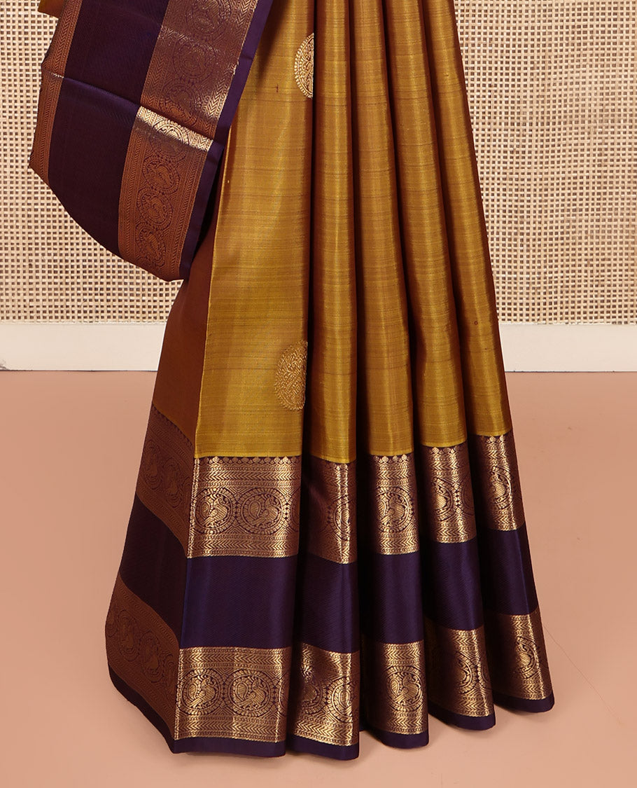 Mustard Kanchipuram Silk Saree, Embellished with Round Buttas All Over Its Body, Complemented by a Contrast Rettai Pettu Border of Thilakam Mokku, Muthu, Kathir, and Round Mayil Designs, Grand Jaal Pallu, and Paired with a Contrast Blouse