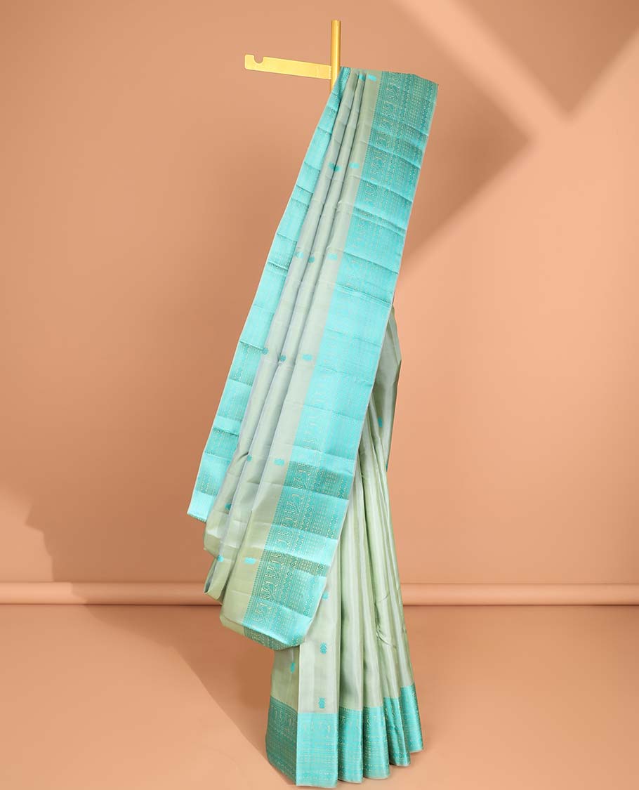Green buttas kancheepuram silk saree with contrast border of intricate zari design & striped floral design pallu