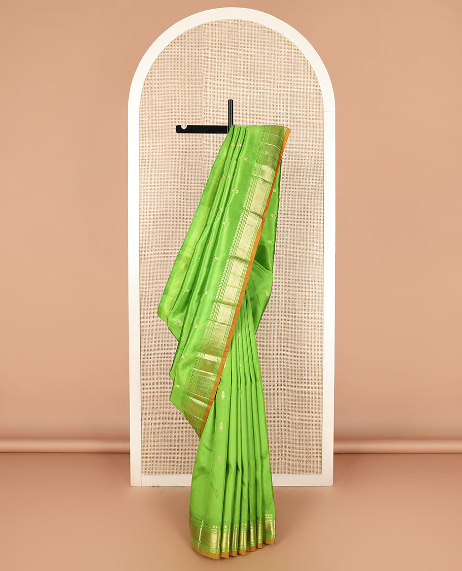 Green zari buttas Kanchipuram silk saree, zari border of paneer sombu, banaras, muthu, and jaal designs, and zari design pallu