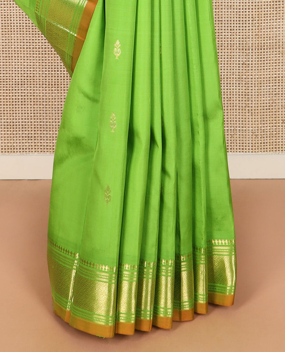 Green zari buttas Kanchipuram silk saree, zari border of paneer sombu, banaras, muthu, and jaal designs, and zari design pallu