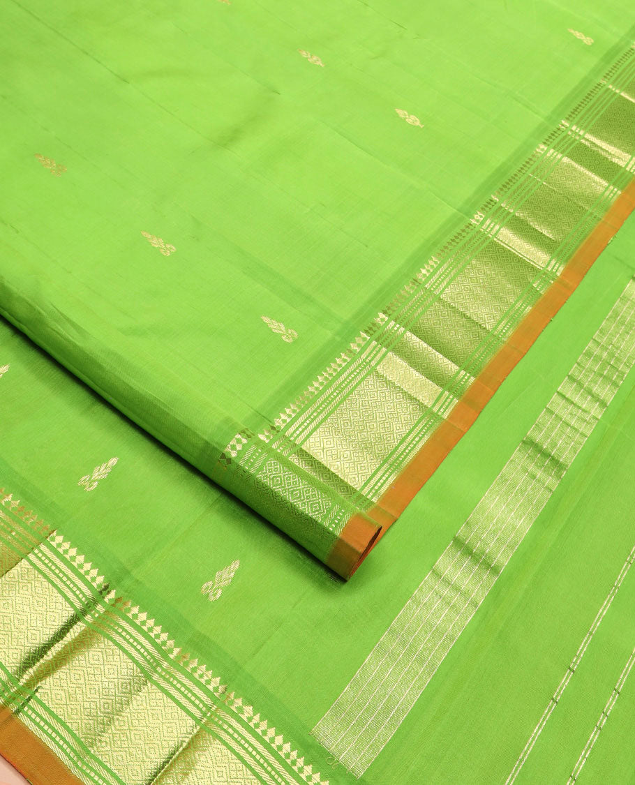 Green zari buttas Kanchipuram silk saree, zari border of paneer sombu, banaras, muthu, and jaal designs, and zari design pallu