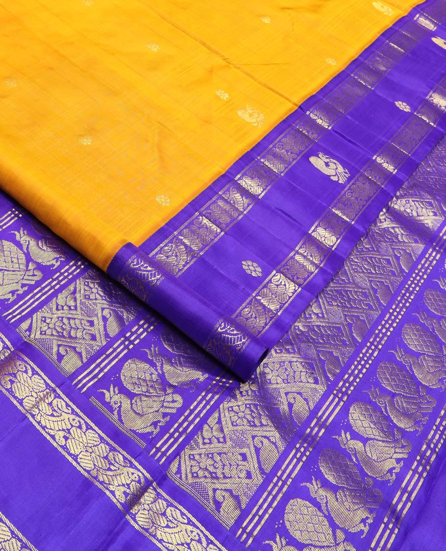 Yellow zari buttas Kanchipuram silk saree, contrast korvai one-sided border of mayil, kamalam, and kodi visiry designs, and pallu of intricate designs