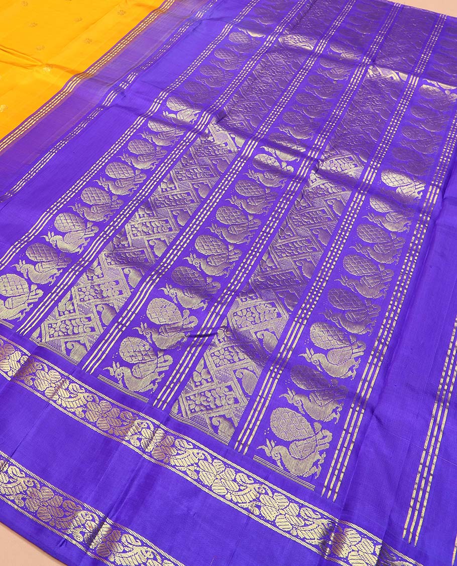 Yellow zari buttas Kanchipuram silk saree, contrast korvai one-sided border of mayil, kamalam, and kodi visiry designs, and pallu of intricate designs