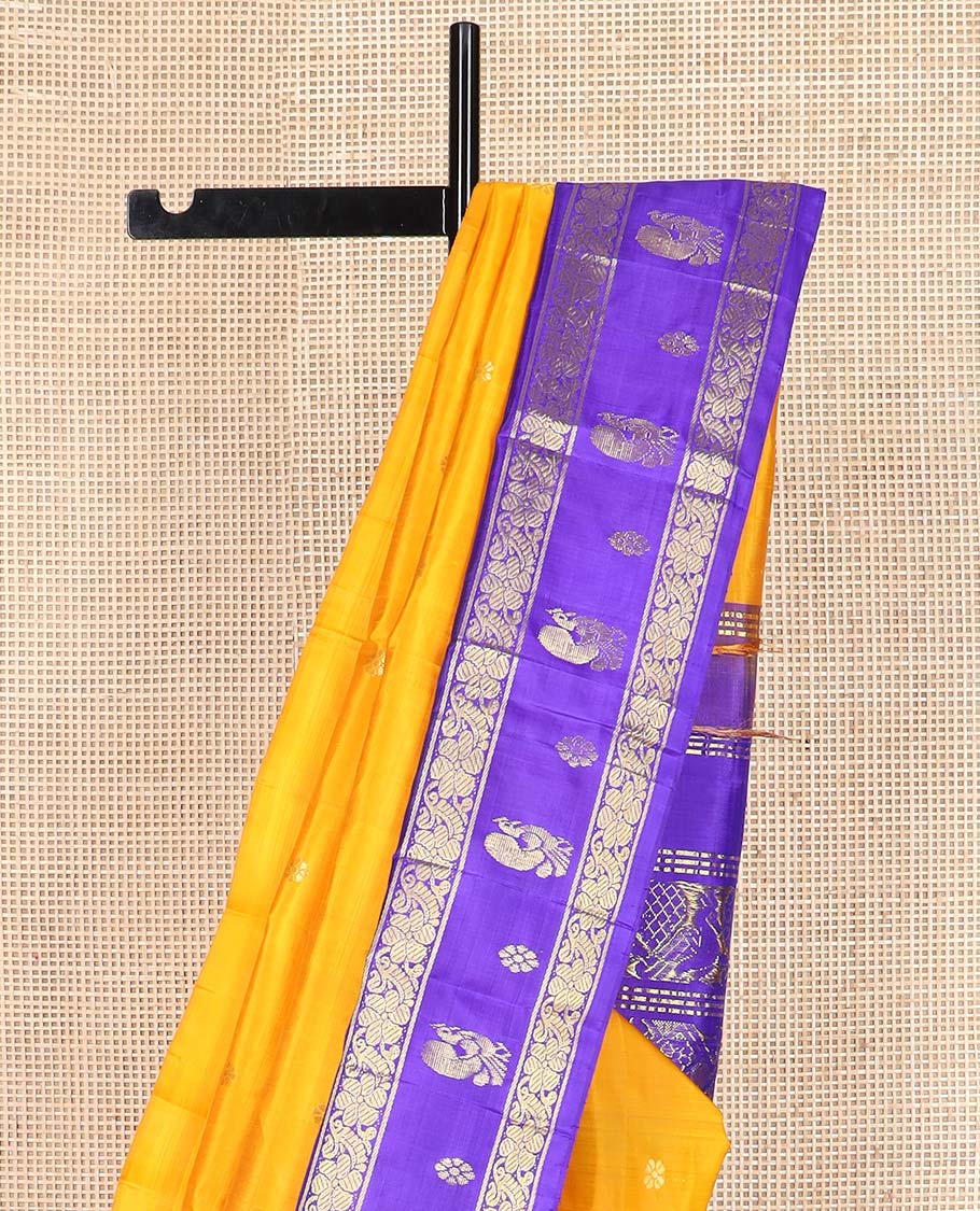 Yellow zari buttas Kanchipuram silk saree, contrast korvai one-sided border of mayil, kamalam, and kodi visiry designs, and pallu of intricate designs