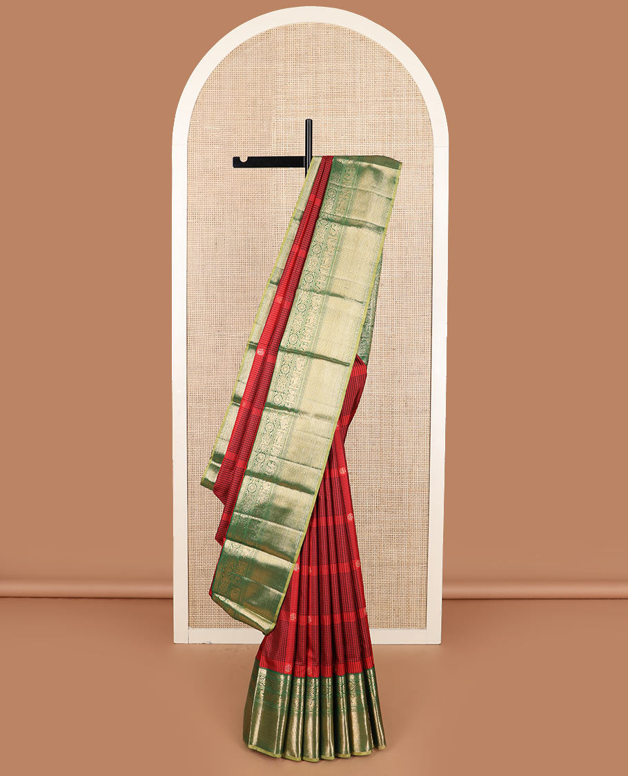 Red checked and buttas Kanchipuram silk saree, contrast border of muthu, rudraksham, chakram, jada nagam, yaanai, mayil, and vanki designs, and intricate pallu