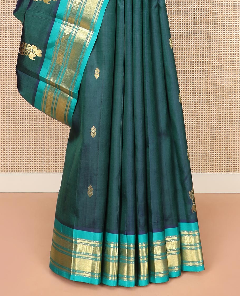Green Kanchipuram Silk Saree, Finely Woven with Zari Buttas All Over Its Body, Complemented by Contrast One-sided Border Featuring Muthu, Kathir, and Vanki Designs, Zari Elevated Pallu of Jaal Designs, and Comes Without a Blouse