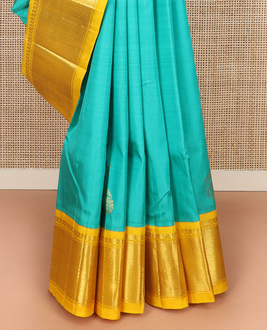 Turquoise Kanchipuram Silk Saree Prettified with Zari Buttas All Over Its Body, Complemented by Contrast One-Sided Korvai Border of Manga Mokku, and Vanki Designs, Pallu Steeped with Floral-Paisley Designs, and Comes Without a Blouse