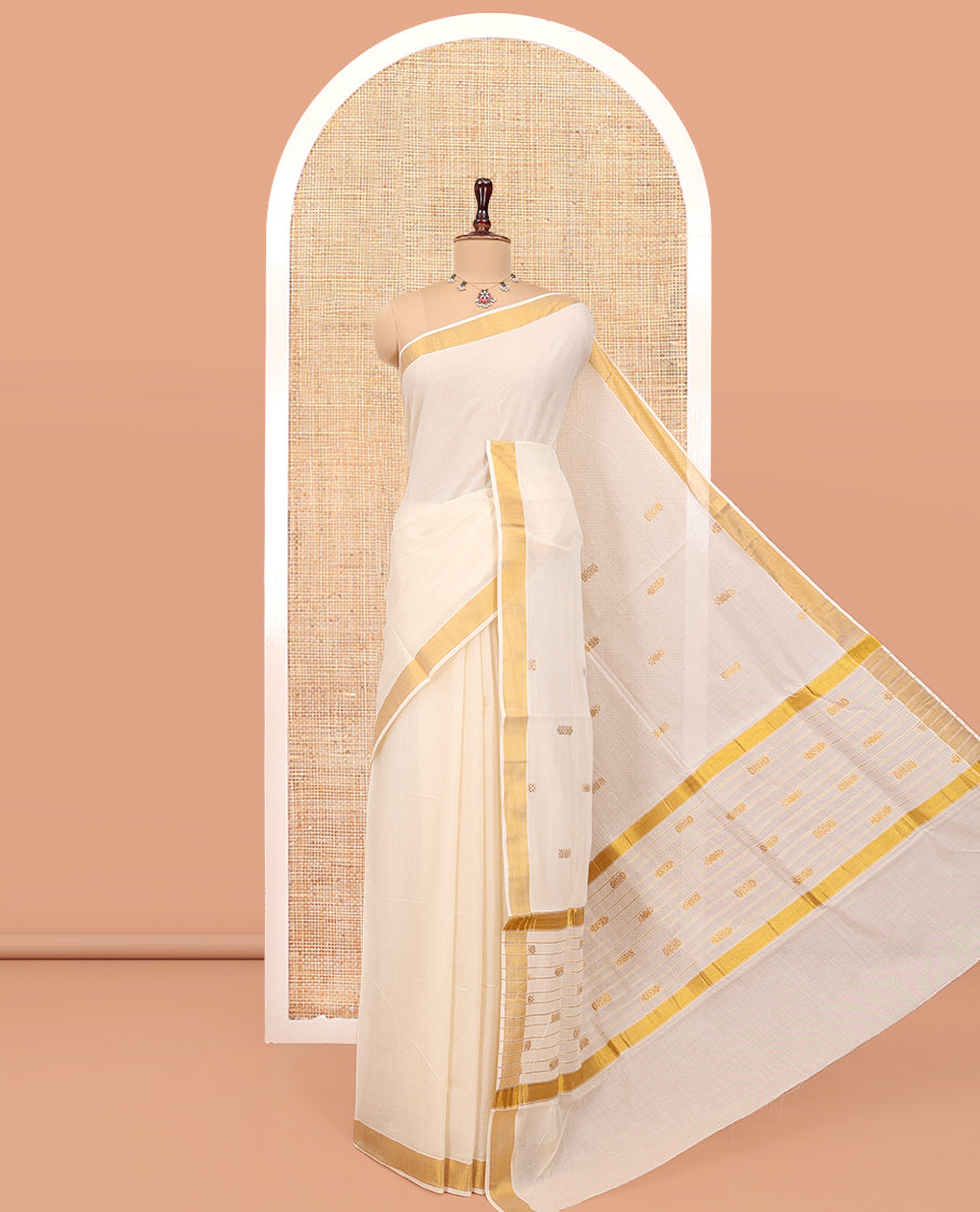 Cream Kerala Cotton Saree, Steeped with Zari Buttas All Over Its Body, a Subtle Bavanji Border, Pallu Features Stripes and Buttas, and Is Paired with a Matching Blouse