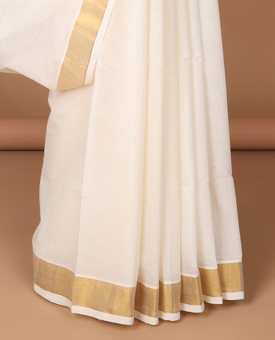 Cream kerala saree with zari stripes, zari border & pallu of peacocks