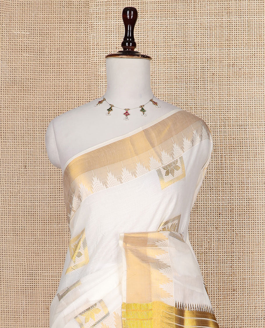 Cream zari Pichwai lotus buttas Kerala saree, zari temple border, and pallu of Pichwai lotus motifs