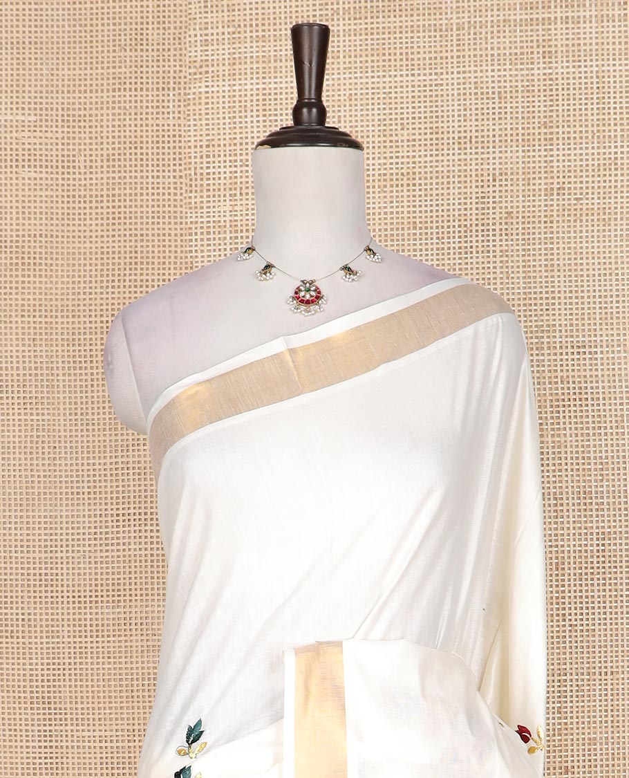 Cream floral motifs embroidered Kerala cotton saree, bavanji border, and peacock embroidered pallu