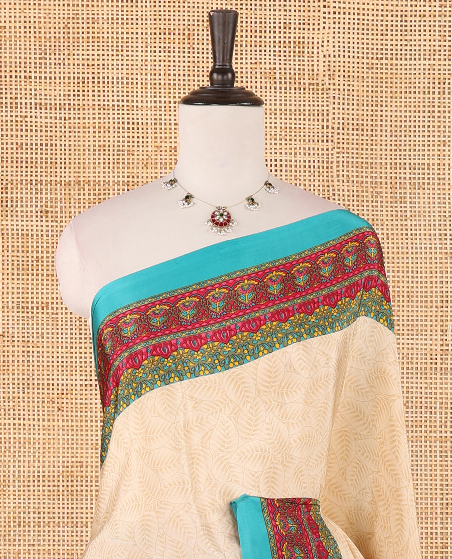 Cream leaf motifs printed crepe silk saree, contrast blue printed blouse, kaleidoscope coloured intricately printed border & pallu