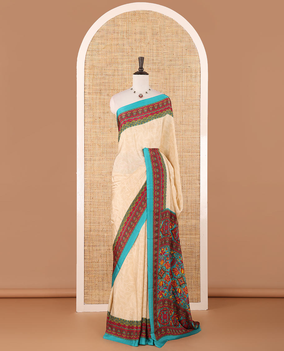 Cream leaf motifs printed crepe silk saree, contrast blue printed blouse, kaleidoscope coloured intricately printed border & pallu