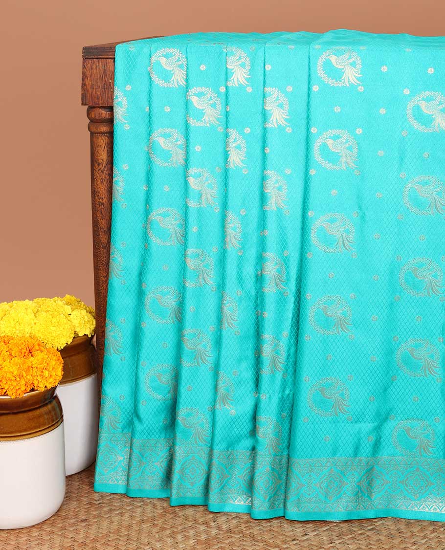Emerald blue allover embosed with gold zari figure design , zari weaving rich pallu with tussels & self small butta blouse