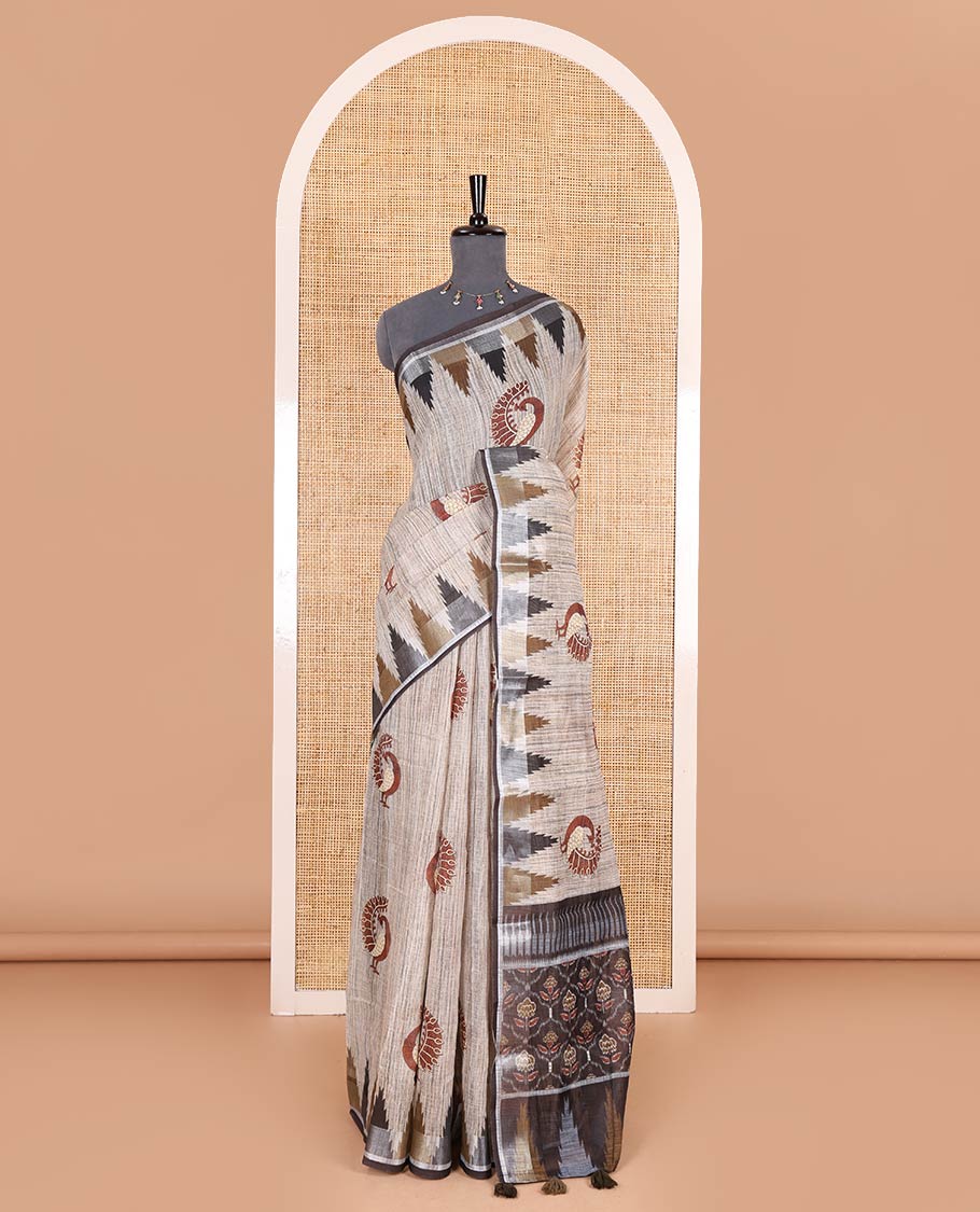 Chikku peacock motifs printed linen cotton saree, zari temple border, floral butta enclosed jaal printed pallu, and contrast buttas blouse