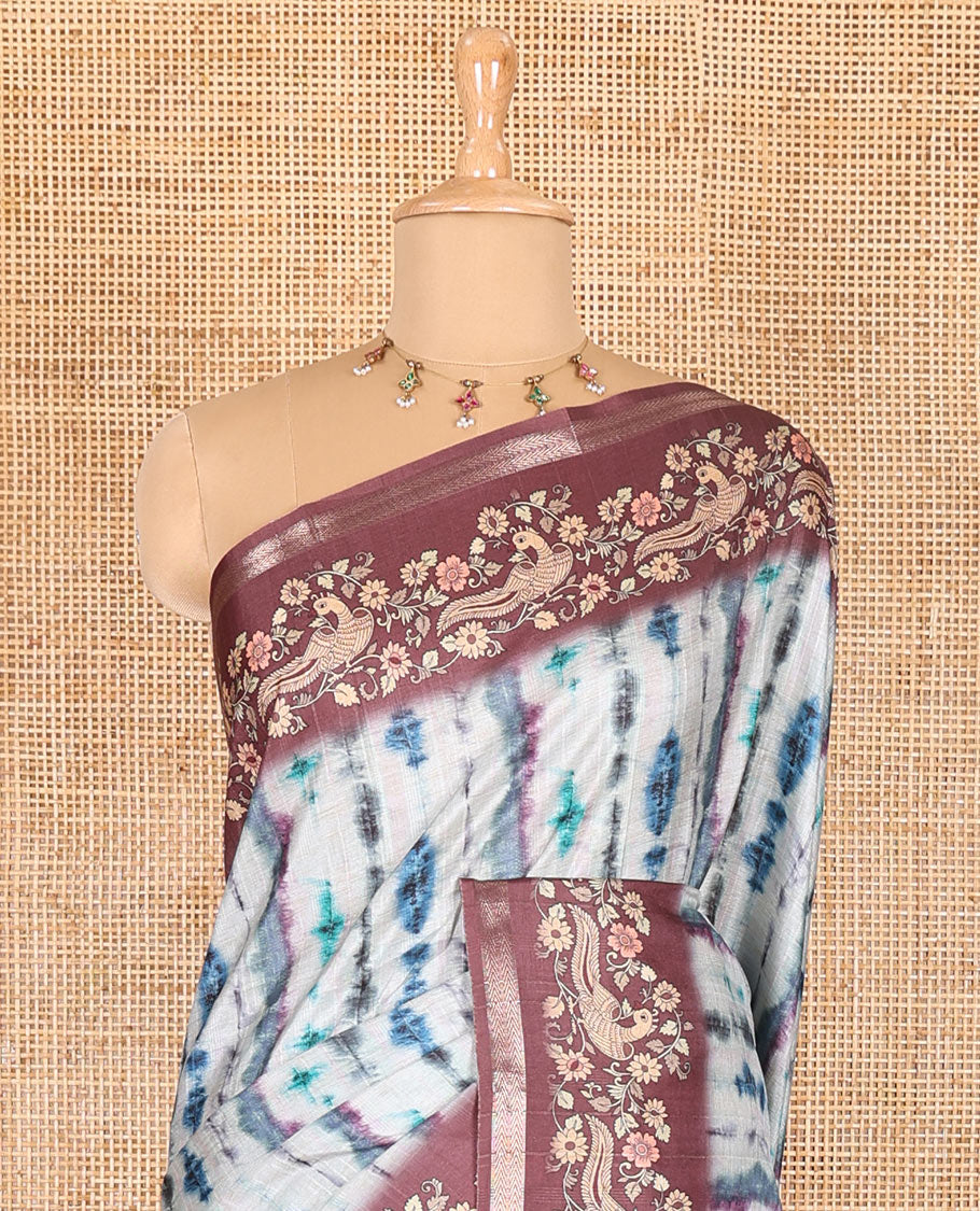Blue shibori printed katan silk saree, contrast border, and pallu of kalamkari floral vine and peacock print, and a contrast leaf printed blouse