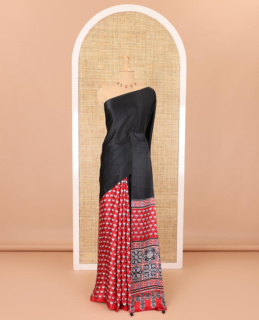 Borderless black-red half-and-half style, intricately Ajrakh printed satin crepe saree with a contrast lotus floral printed blouse