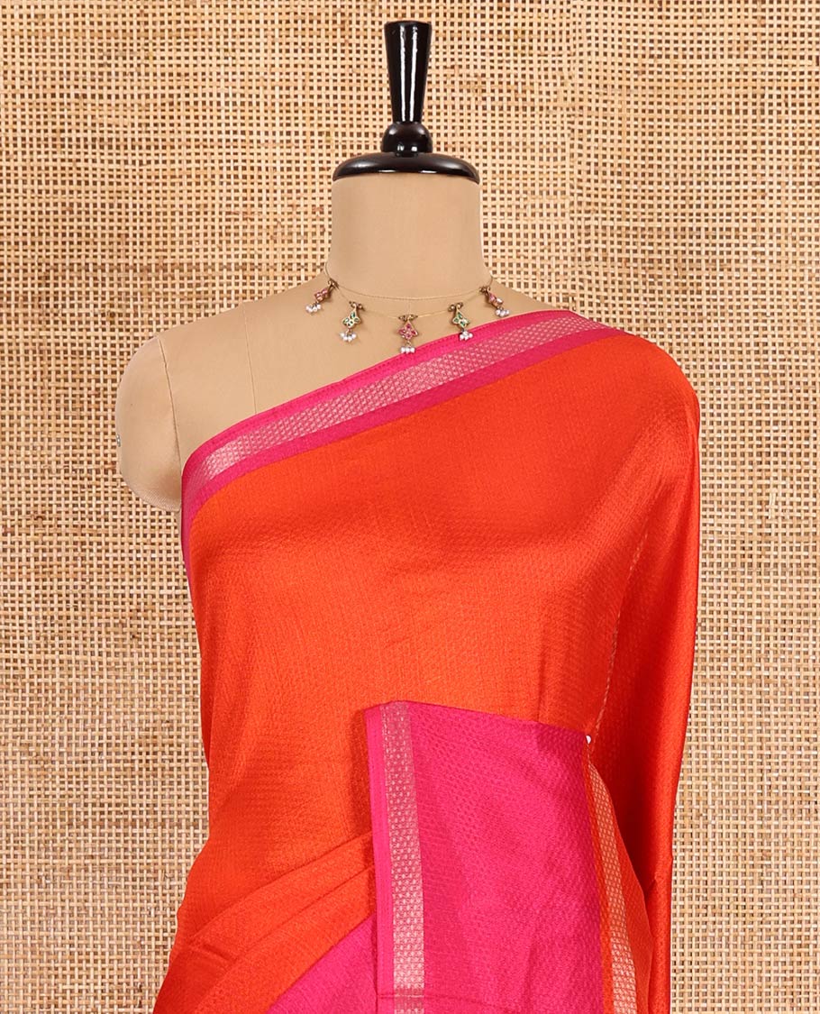 Orange embossed moss chiffon saree, contrast traditional rettai pettu border, embossed pallu, and a contrast embossed blouse
